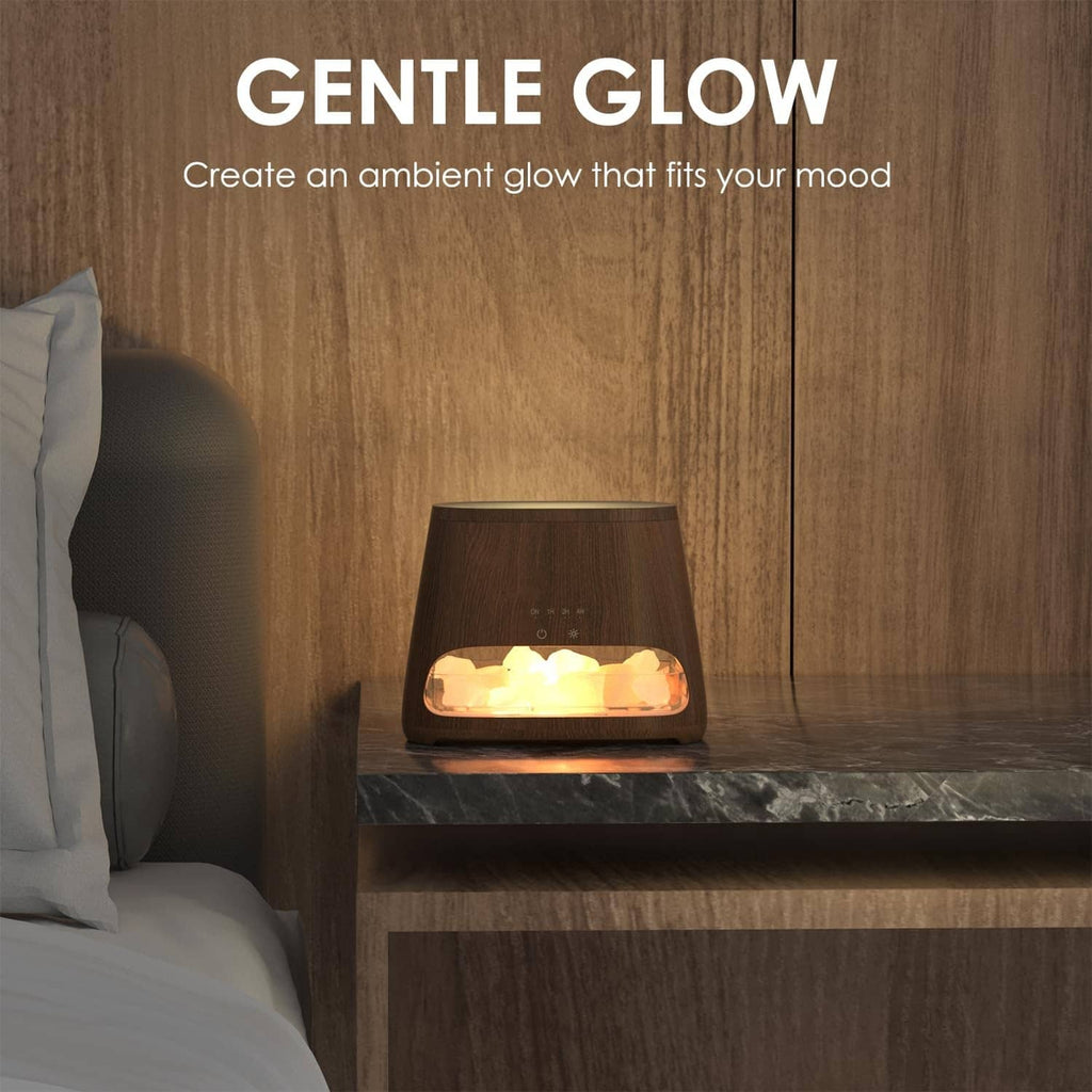 Dark wood salt lamp diffuser humidifier emitting warm glow from pink salt-rock tray
