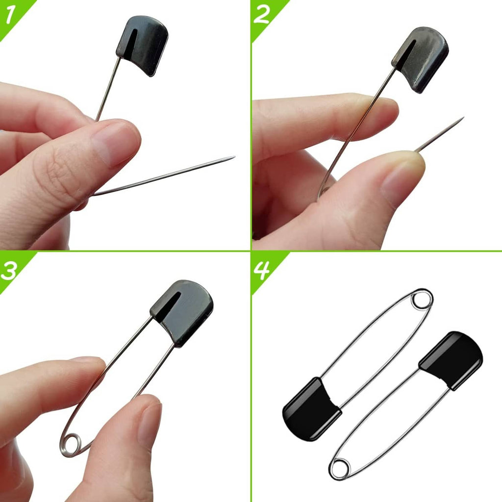 Hand holding a black plastic-head safety pin with metal needle and loop ring