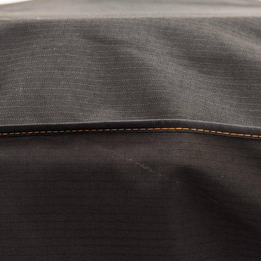 Black smoker cover fabric with orange contrast stitching along top seam