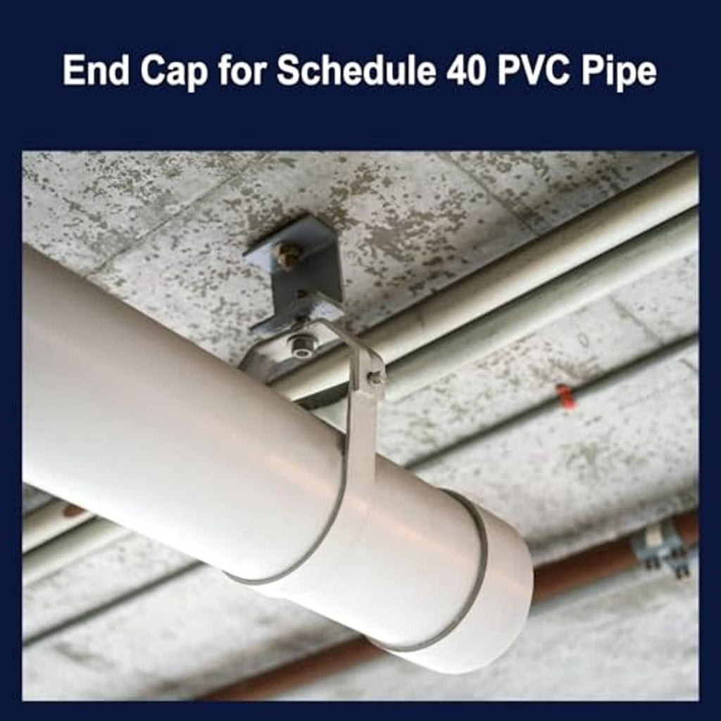 White PVC end cap installed on a pipe end, covering the pipe opening