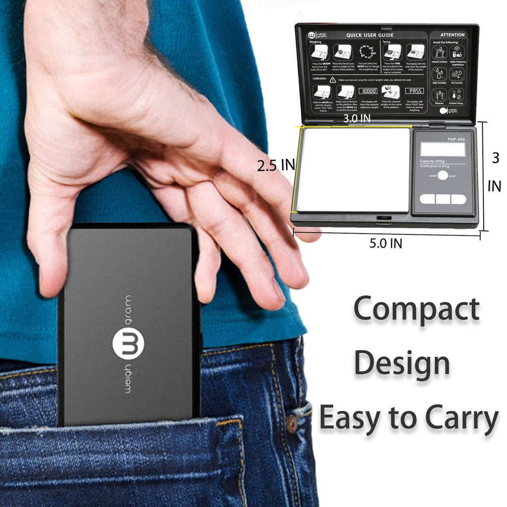 Black compact pocket scale held in a hand, showing blue LCD display