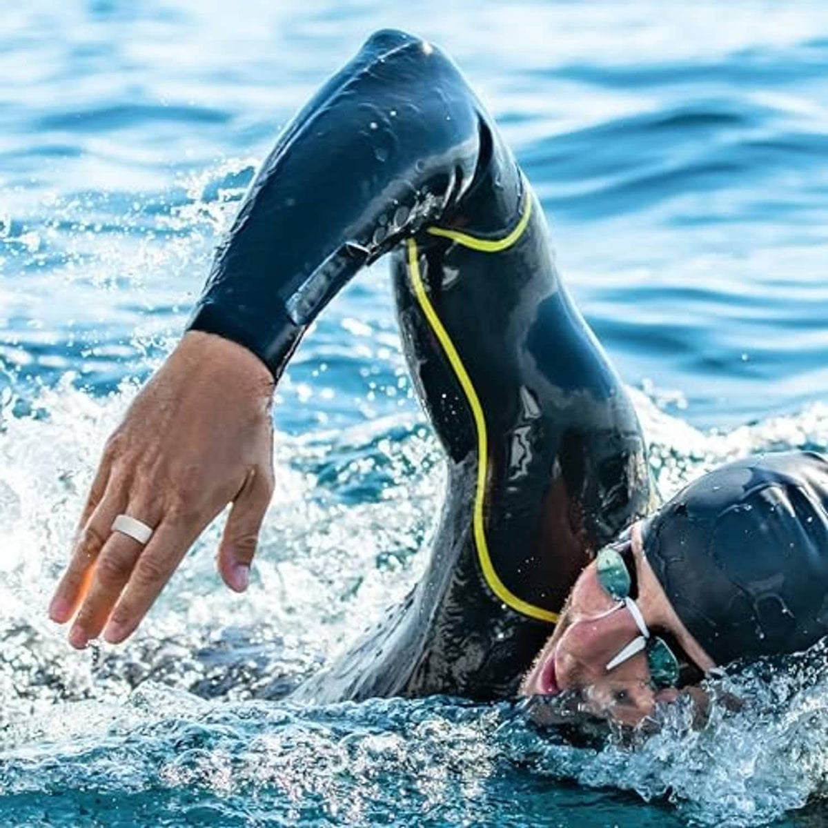 Swimmer’s hand wearing a ring with protective silicone case in water
