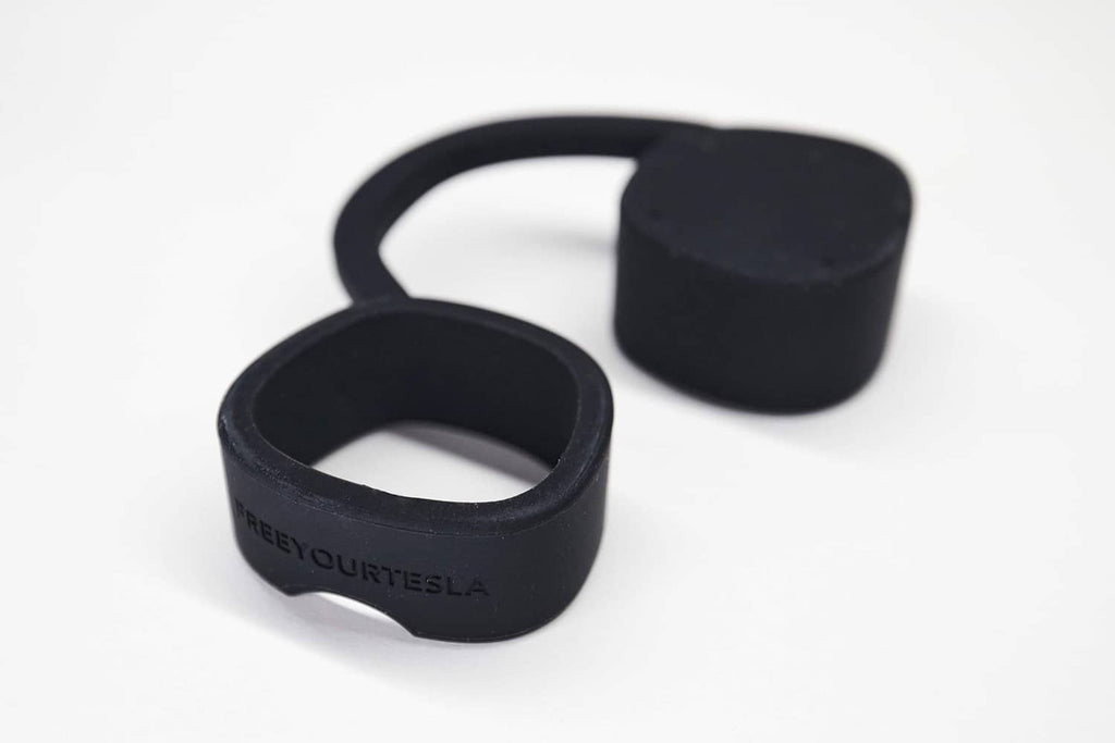 Black silicone Tesla charger cap protector rings, one open and one upright