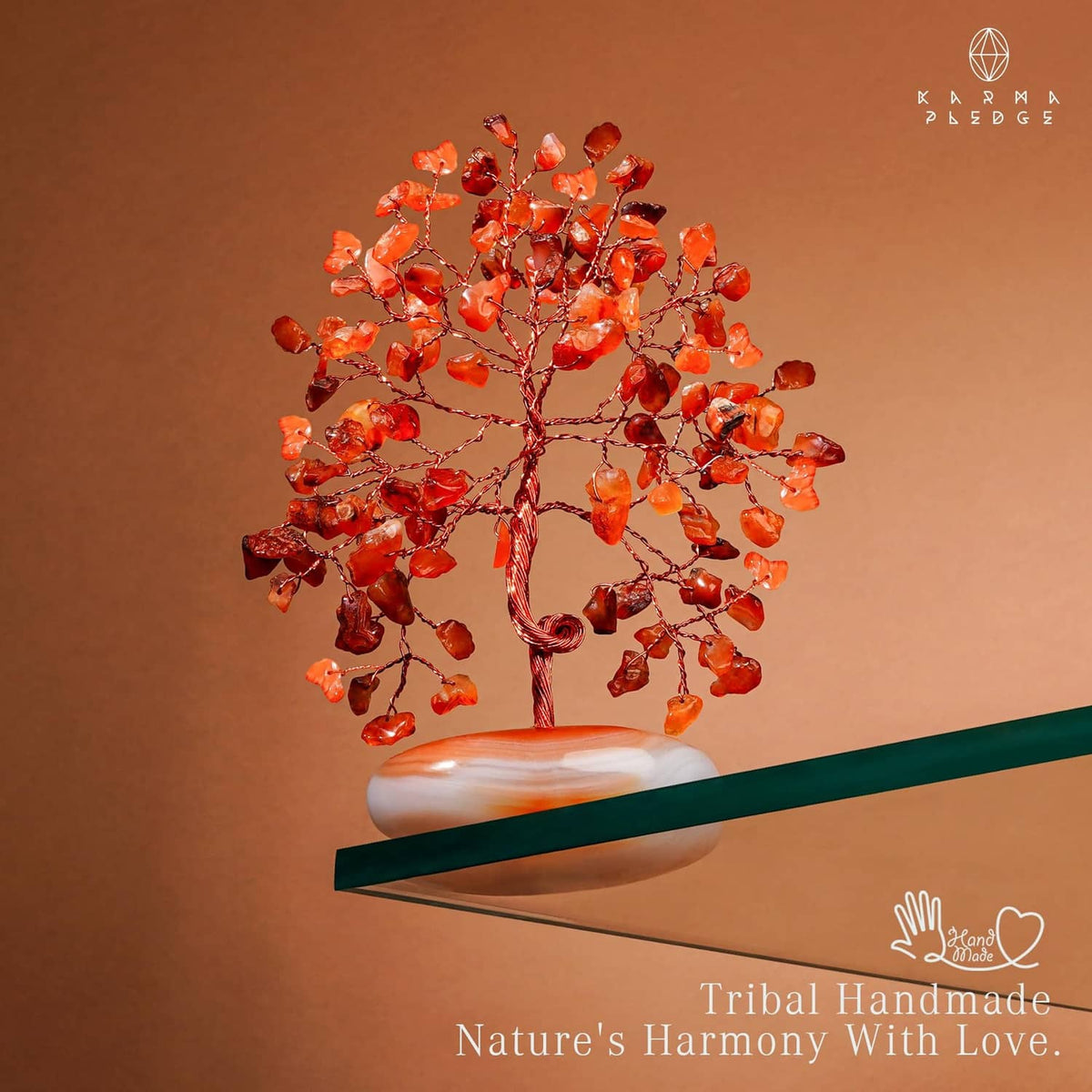 Orange-red carnelian stone tree ornament with curled wire trunk and white base