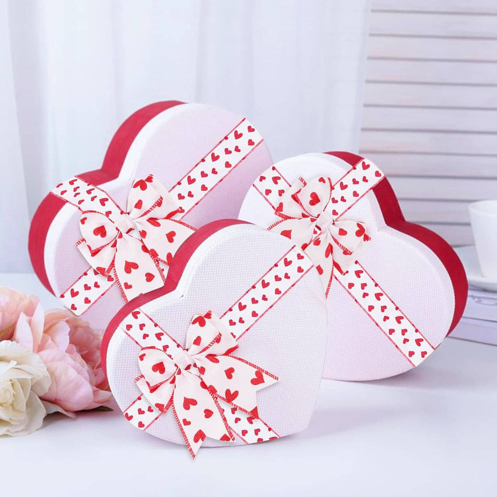 White ribbon with red hearts and wired edge tied into bows on wrapped gifts