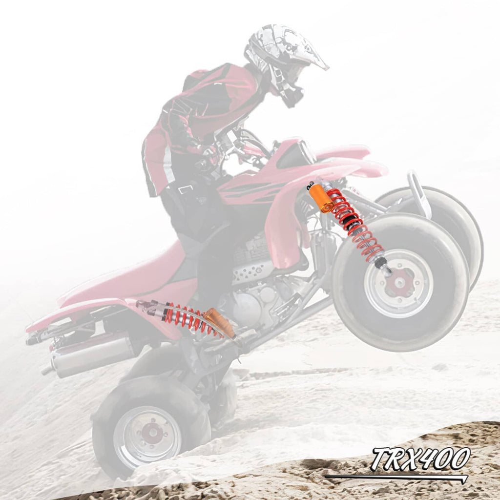 Air shock absorbers on an ATV with red coil springs and orange reservoirs
