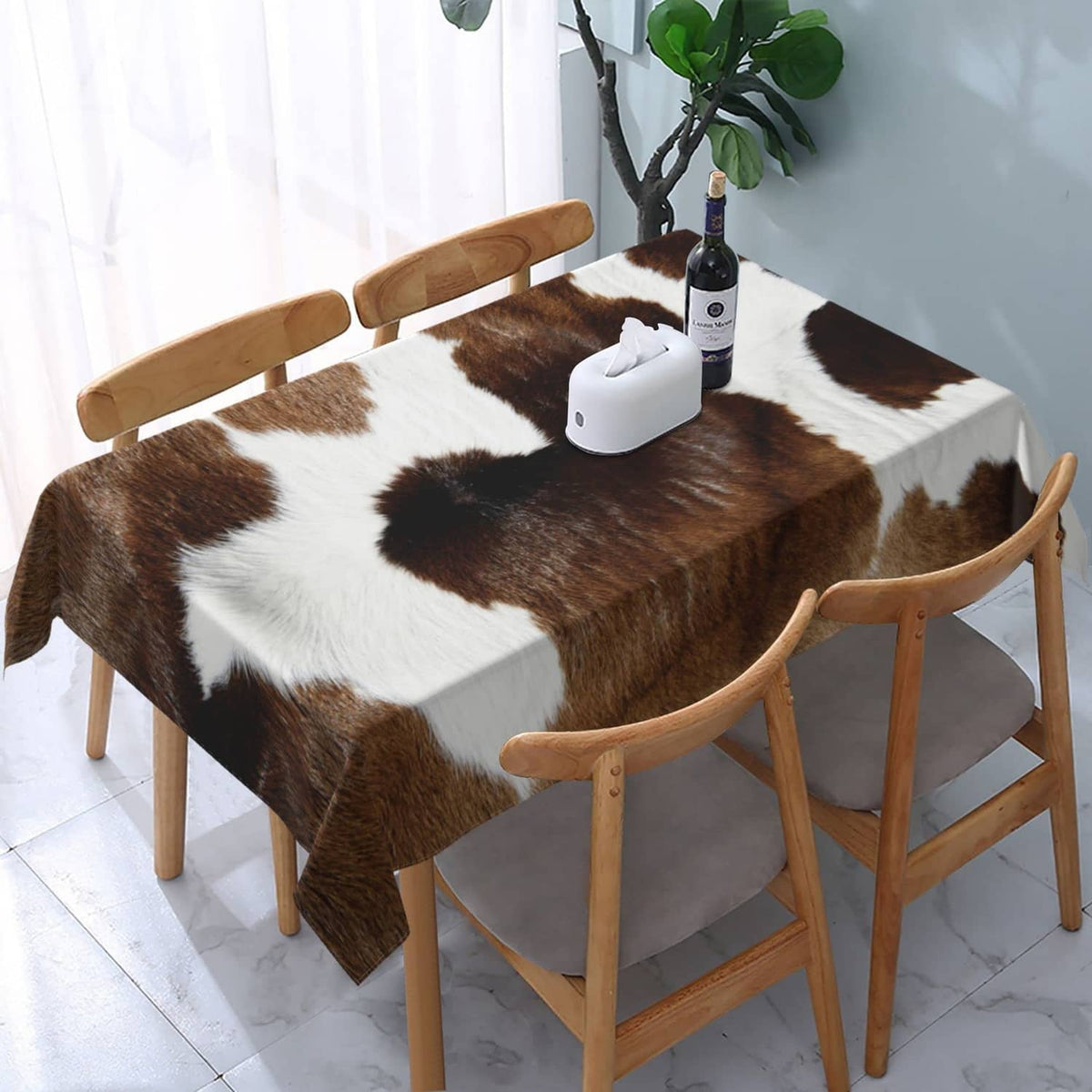 Cowhide-pattern tablecloth in brown and white with full coverage on dining table