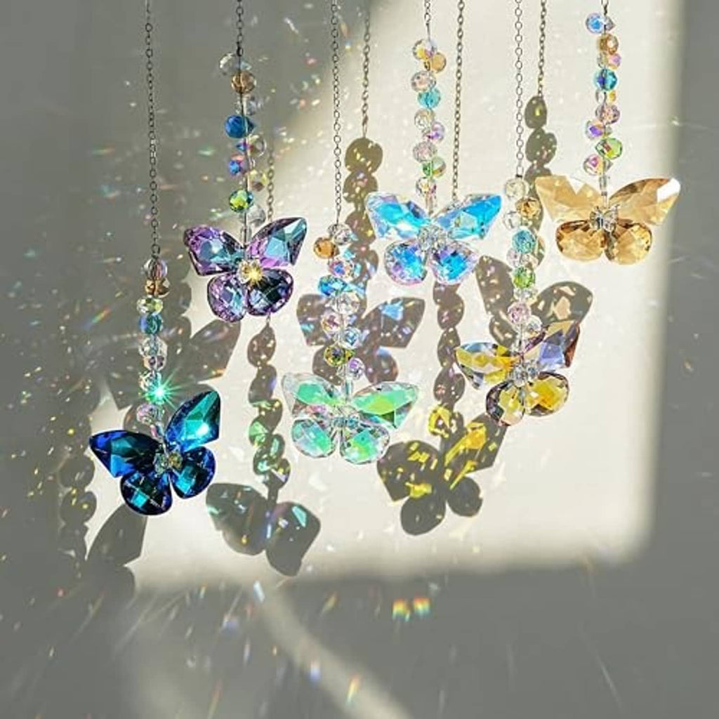 Hanging crystal butterfly suncatchers with multicolor butterfly charms in a window glow