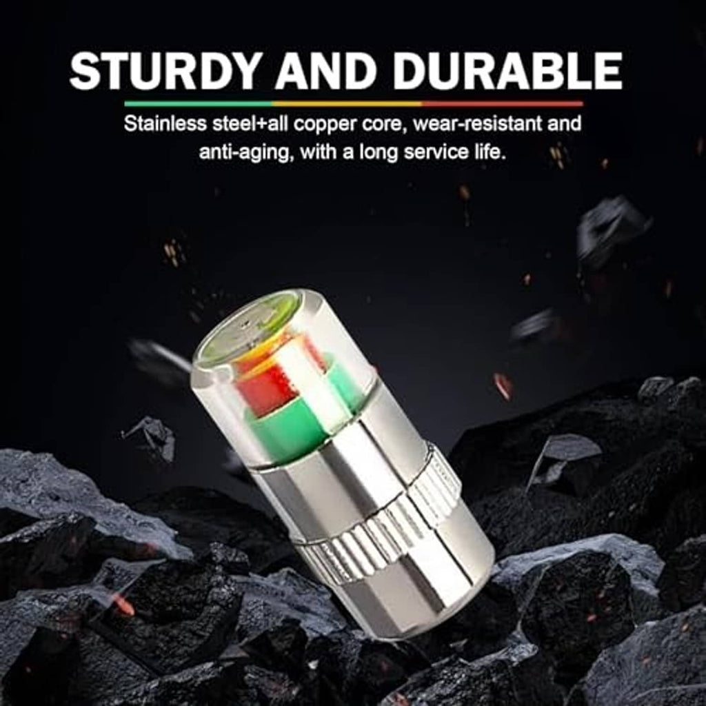 Silver tire valve stem cap with clear colored indicator window on dark pavement