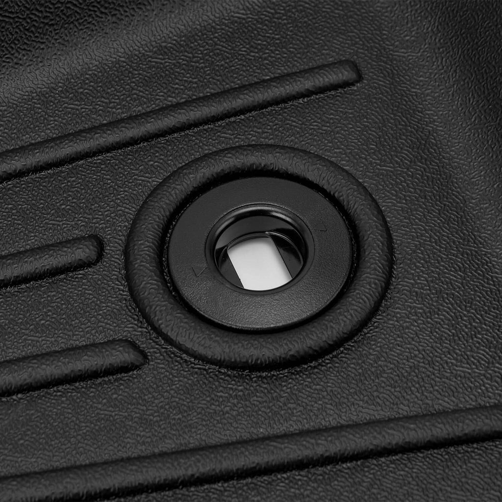 Black TPE floor mat anchor hole with textured surround on molded surface