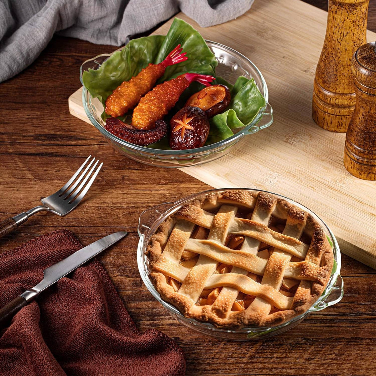 Clear glass pie pan with lattice baked pie on wooden table