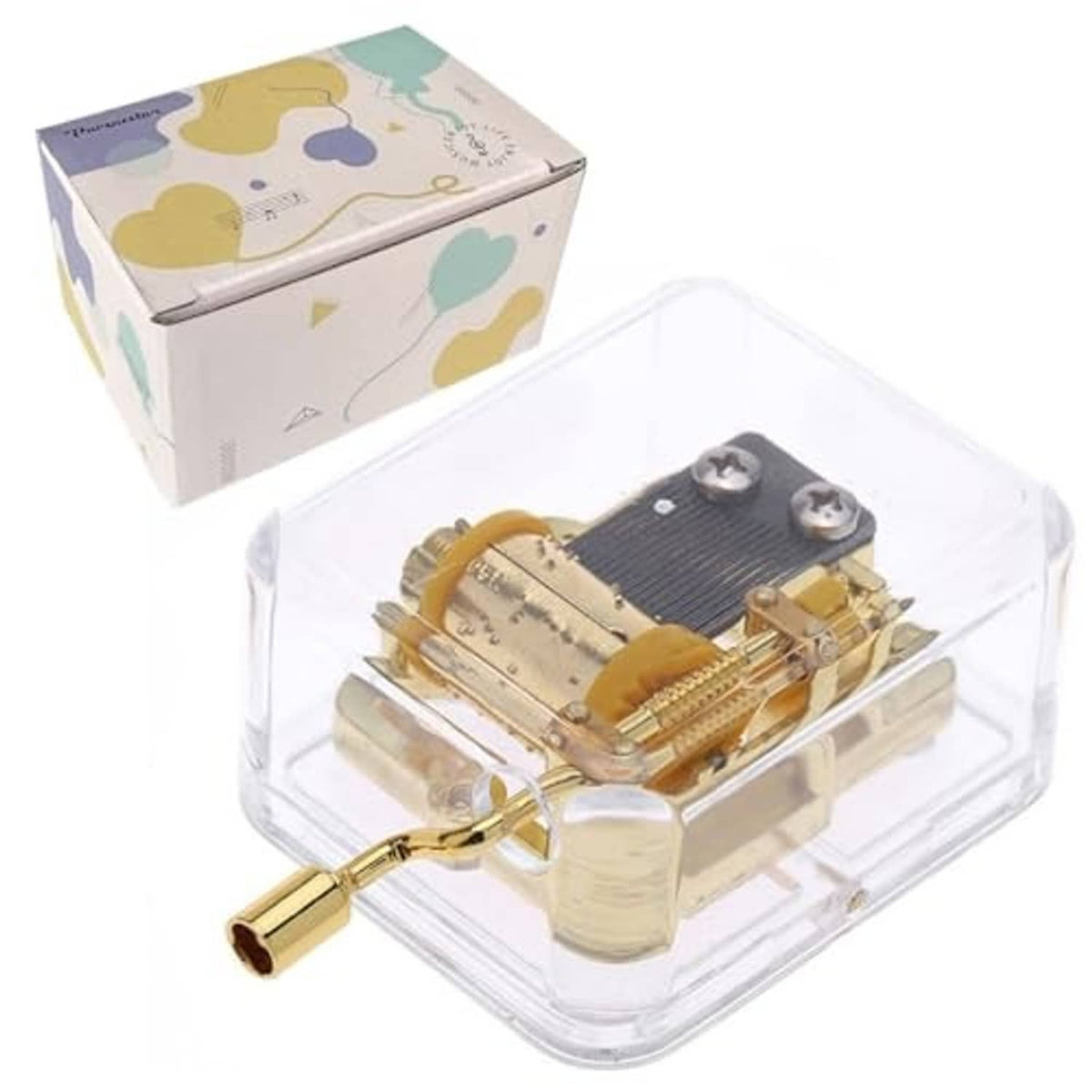 Clear gold hand-crank music box with visible internal mechanism inside a transparent case.