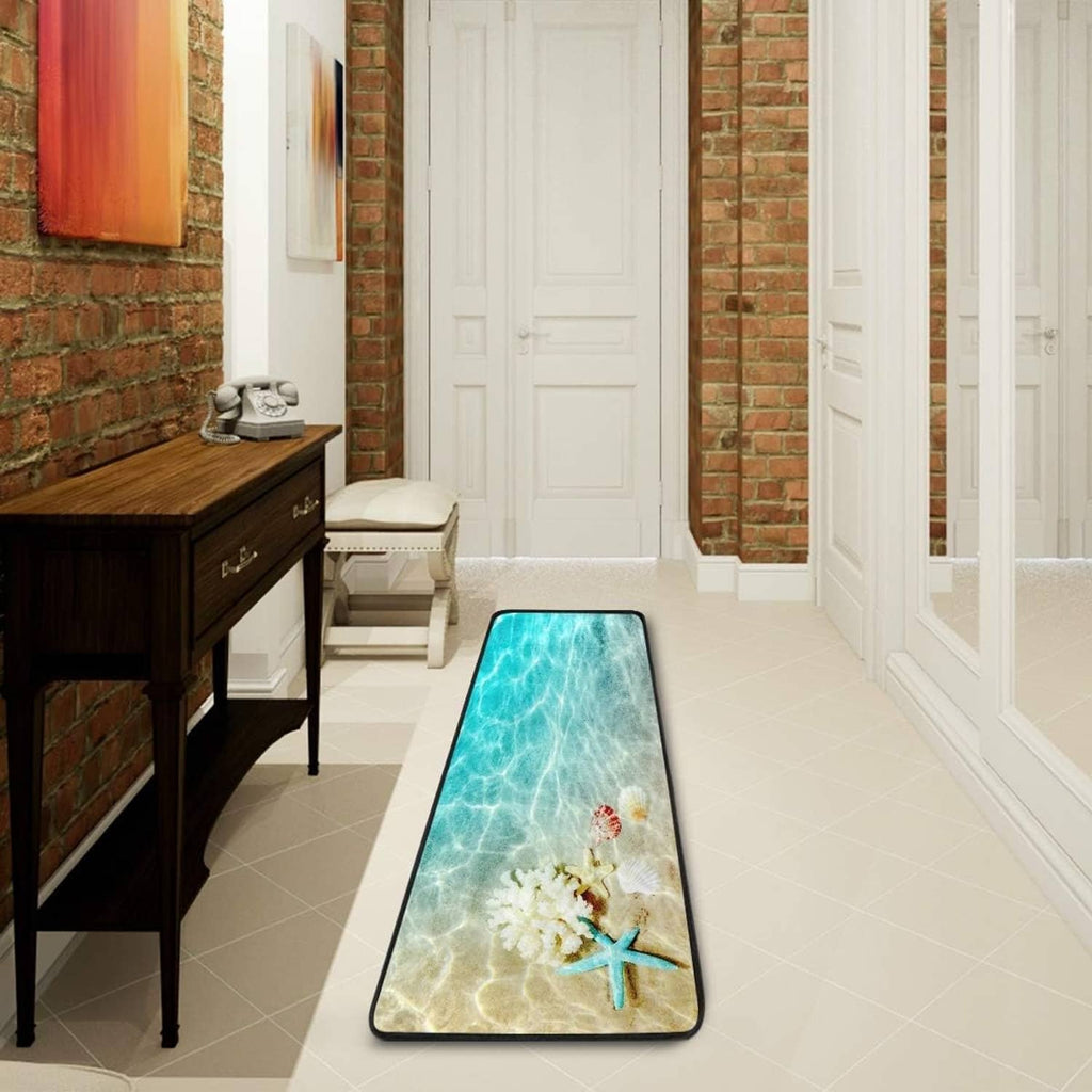 Long rectangular teal ocean print rug with starfish and shell details, black edge trim