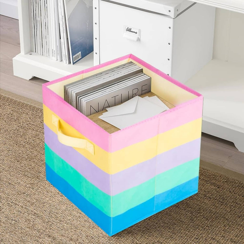 Rainbow striped fabric storage cube with front handle, holding stacked papers
