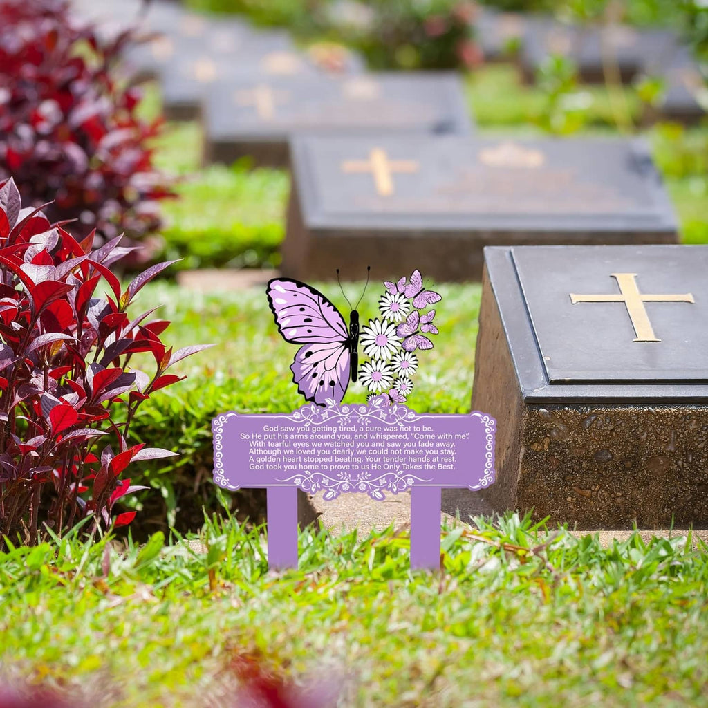 Purple butterfly memorial stake decoration with floral banner on a grave