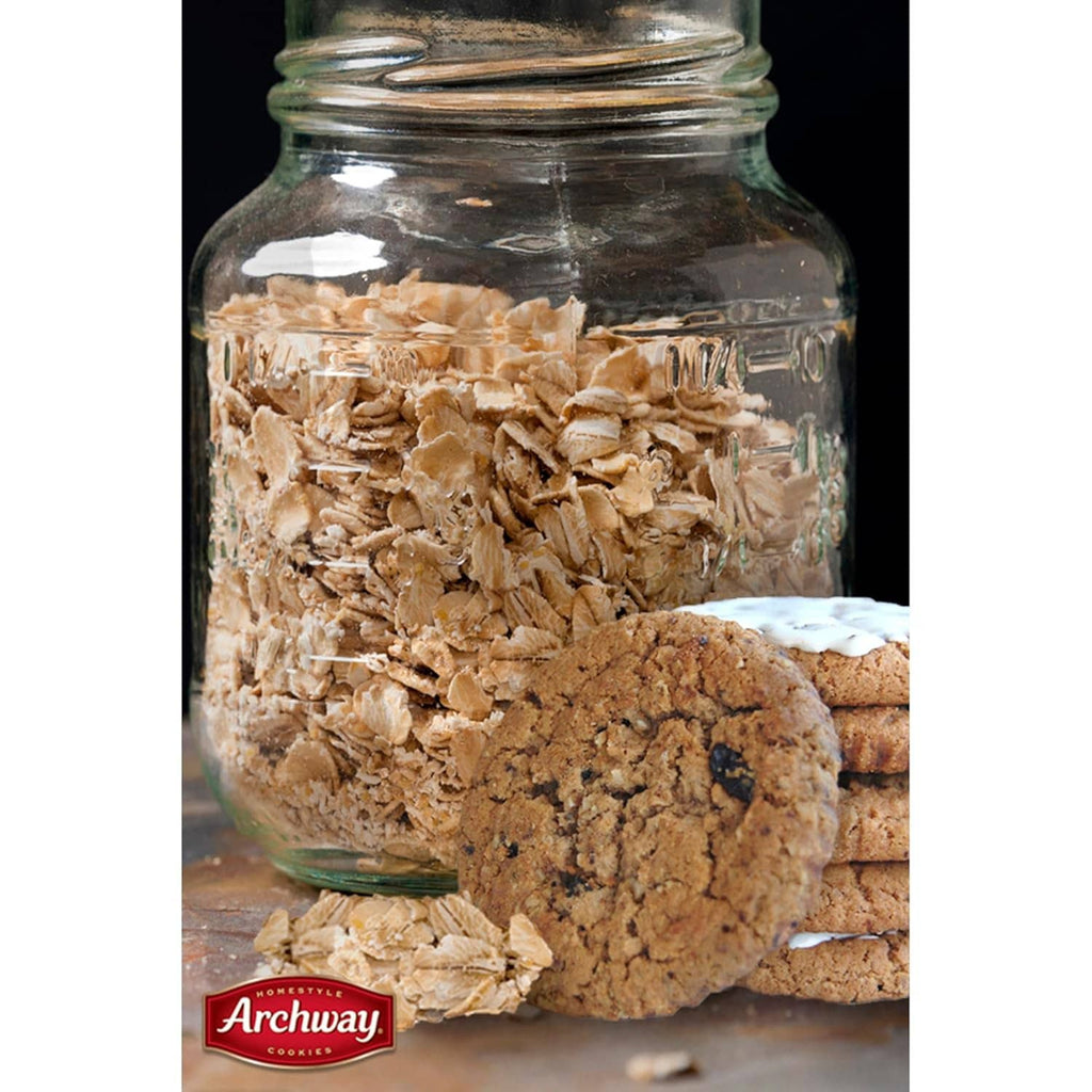 Glass jar filled with oatmeal flakes and soft oatmeal raisin cookies
