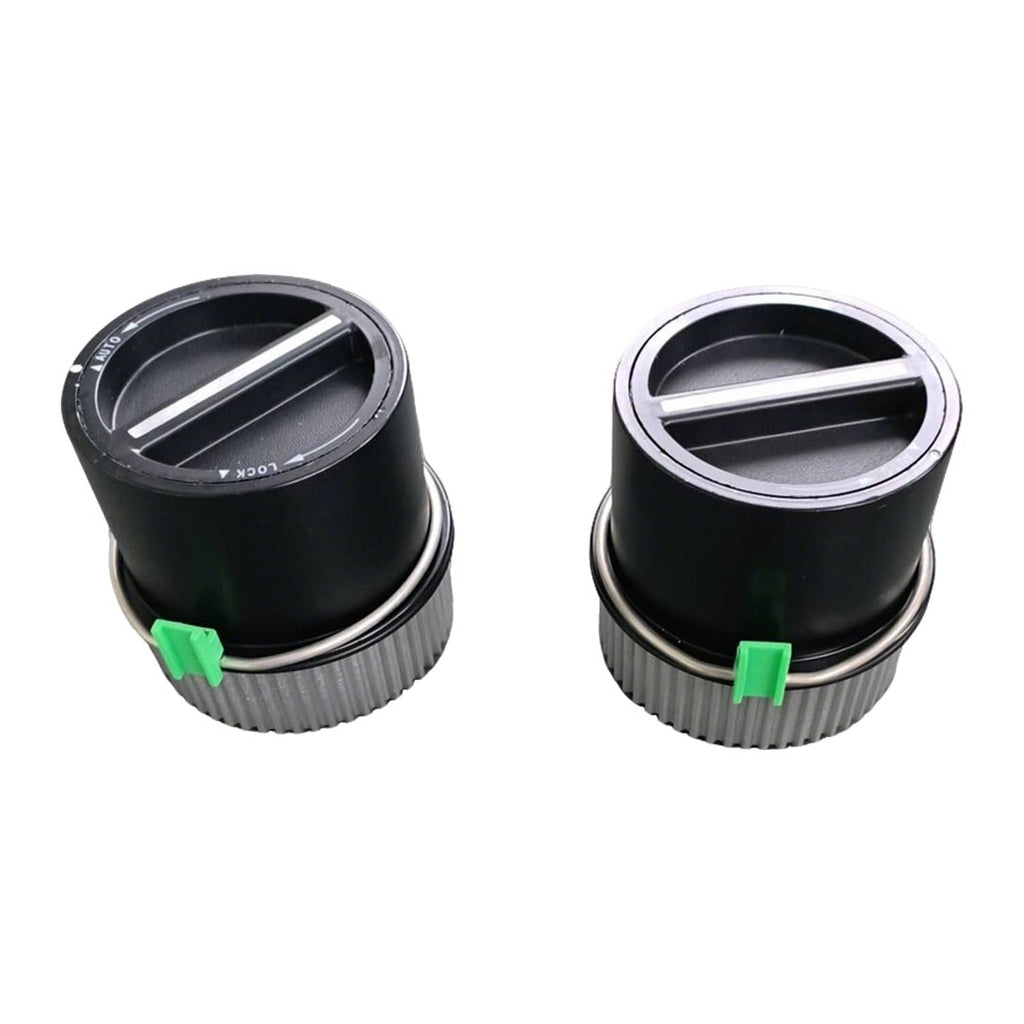 Two black auto-locking hubs with silver ribbed sleeves and green locking tabs