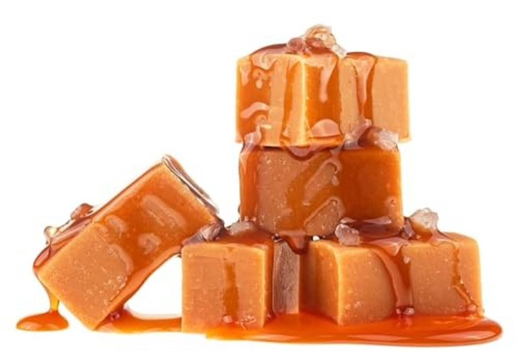 Glossy caramel candy cubes stacked with sauce