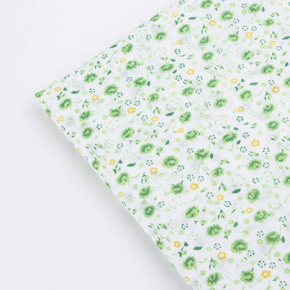 Cotton fabric square with light background and small green floral and leaf pattern
