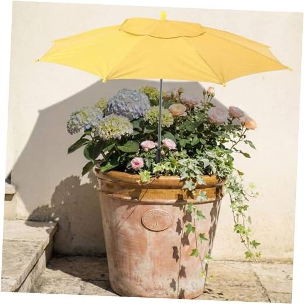Yellow plant shade umbrella over flowering potted plant on a patio