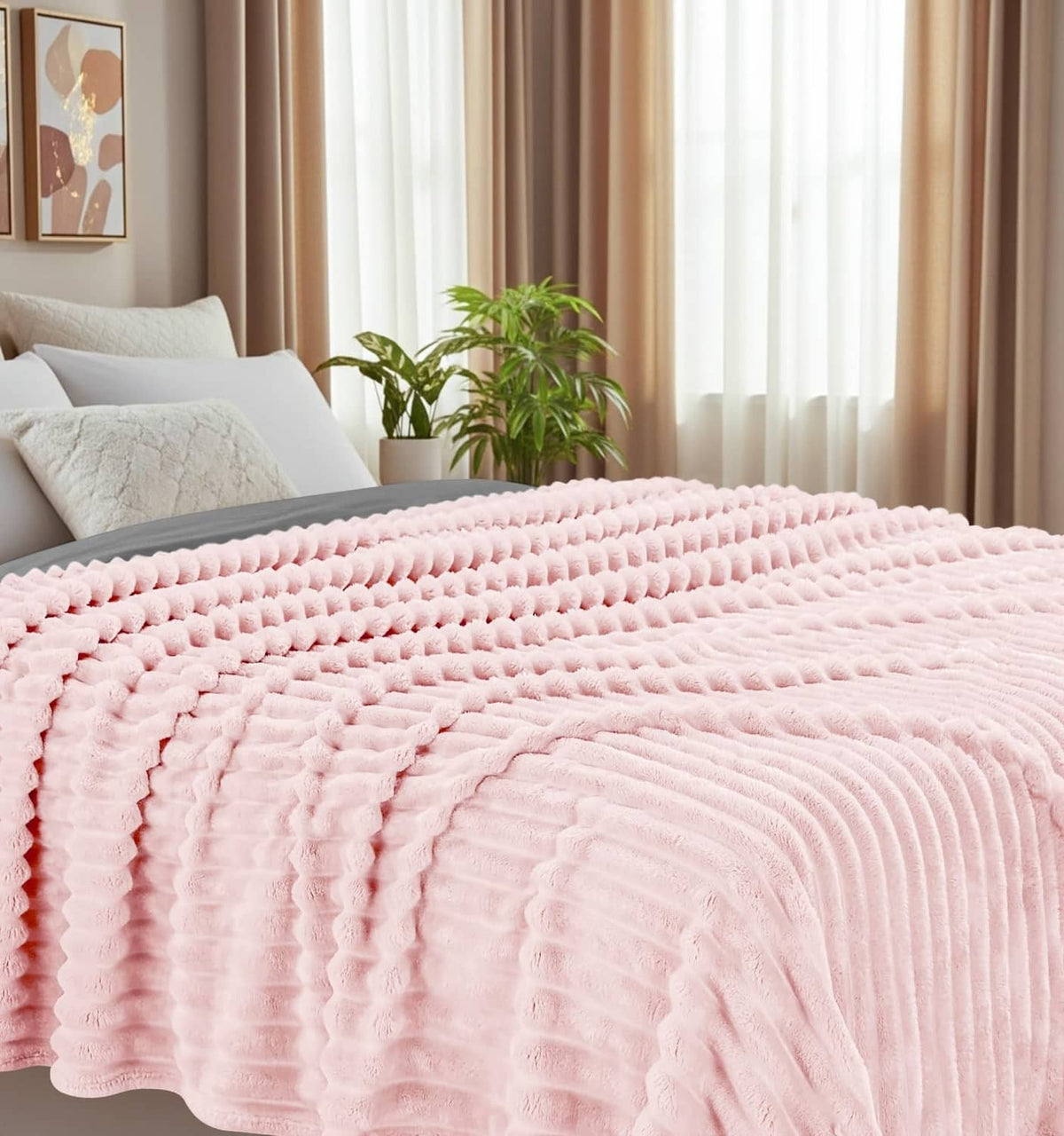 Pink striped fleece blanket spread across a bed, soft plush texture