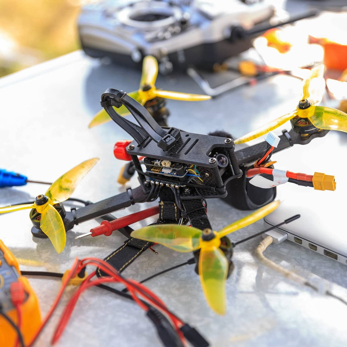 RC quadcopter frame with yellow propellers and controller electronics