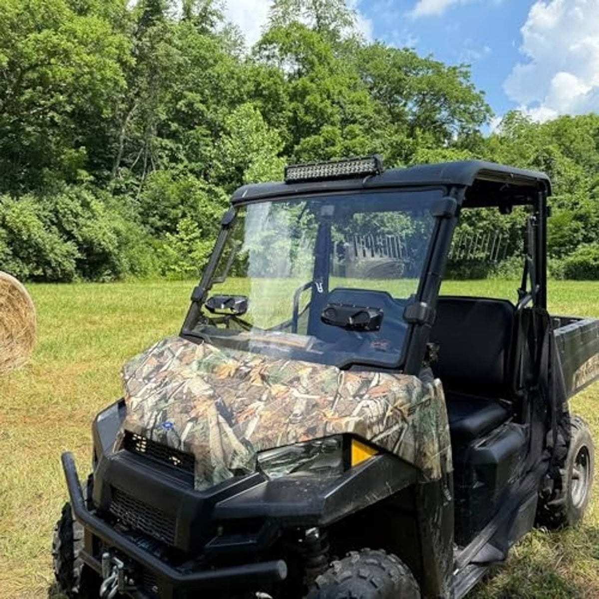 UTV with installed clear vented windshield and black frame surround