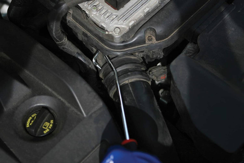 Hook pick tool in a vehicle engine compartment near hoses and wiring