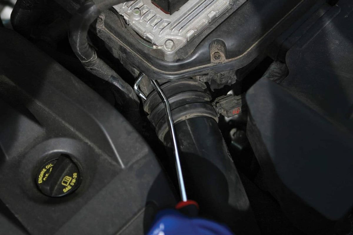Hook pick tool in a vehicle engine compartment near hoses and wiring