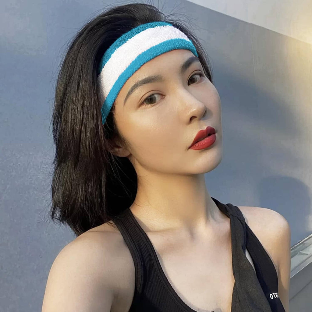 Blue-and-white striped sweatband headband worn over dark hair