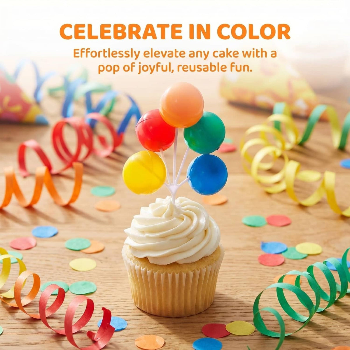 Colorful balloon cake topper on a cupcake with orange, red, green, yellow, blue balloons