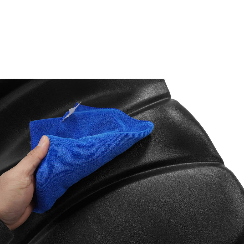 Black vinyl tractor seat with blue cloth wiping the backrest