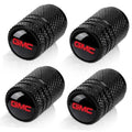 Set of four black textured tire valve stem caps with red GMC logo