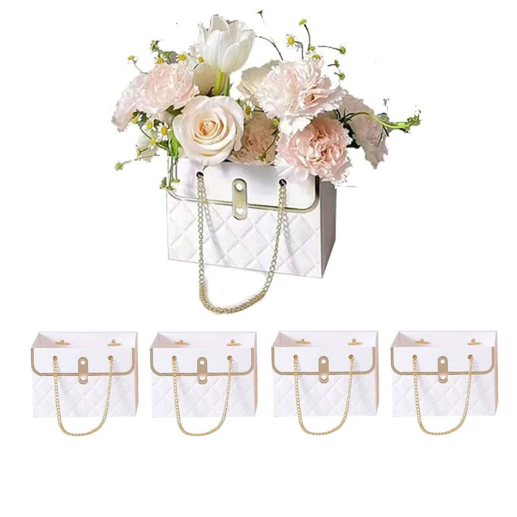 White quilted paper bouquet bag with gold chain handles and front clasp, filled with flowers