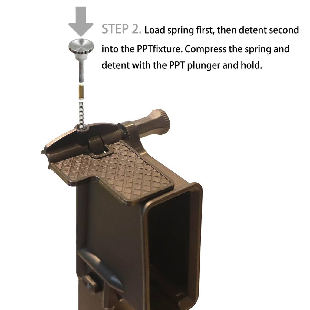 Pivot pin install tool step shown loading the spring; black base and silver plunger.