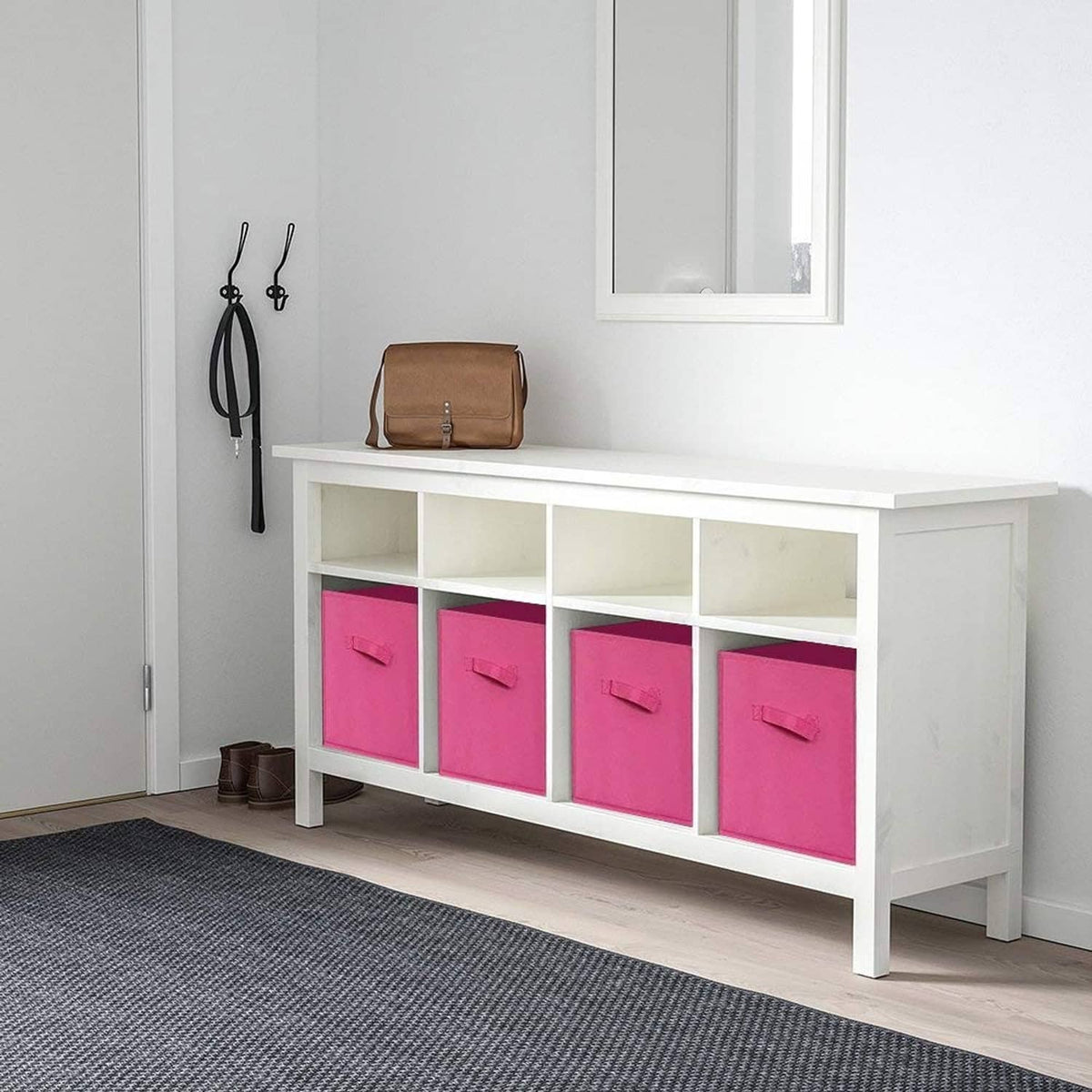 Fuchsia fabric storage cubes in a white cabinet, multiple bins with front handles