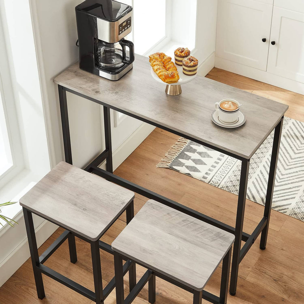 Greige bar stool with black frame, square seat, and lower footrest stretcher