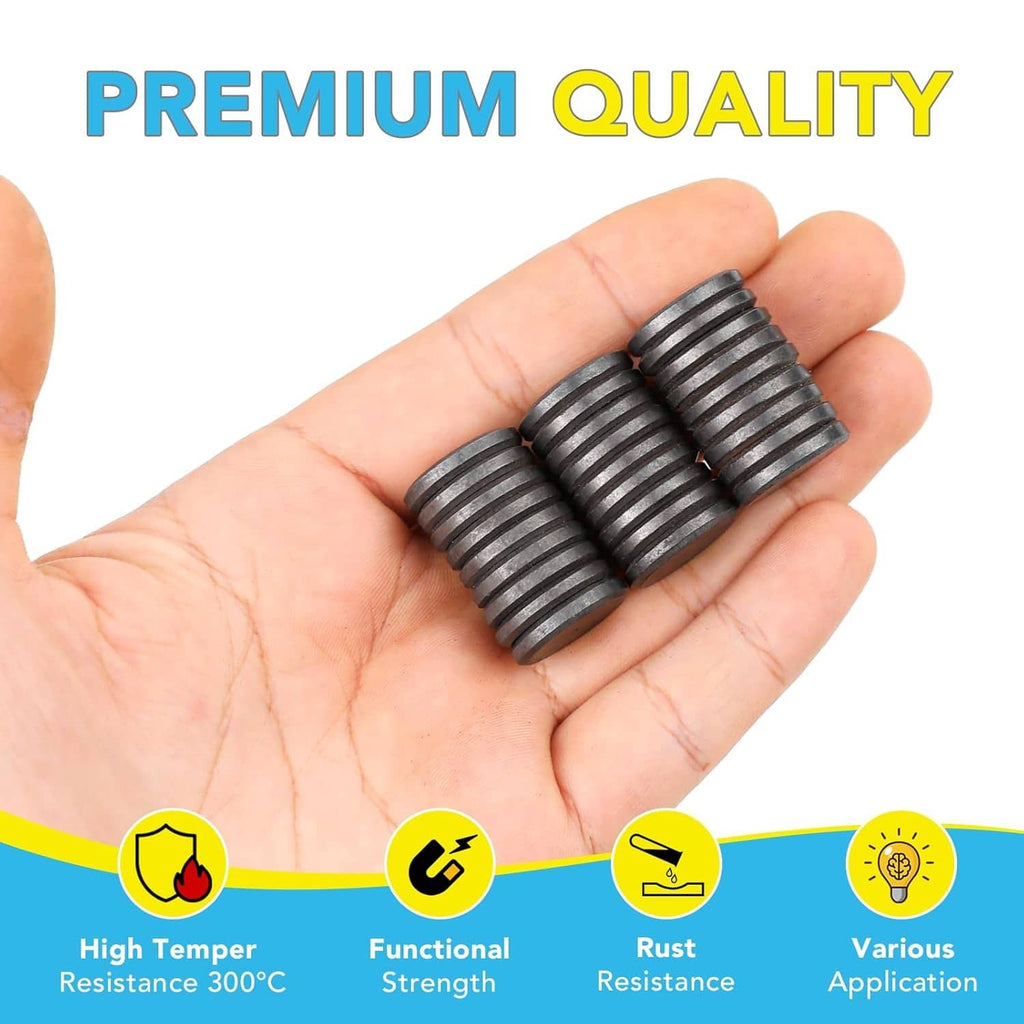 Black ceramic craft magnets, round discs stacked, held in a hand