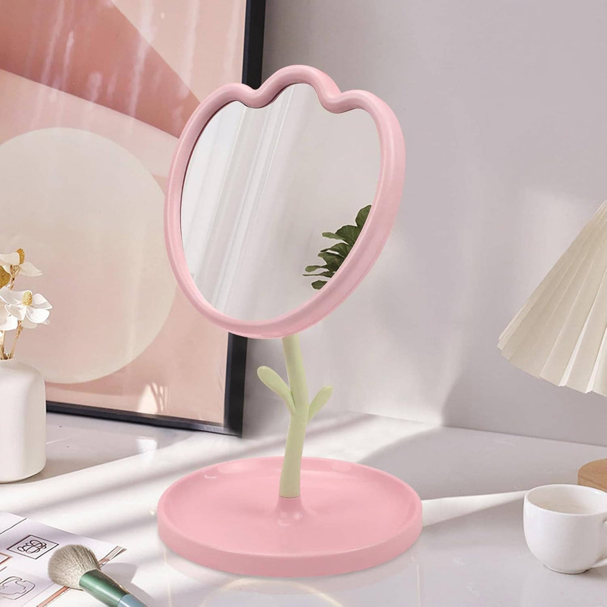 Pink flower-shaped tabletop mirror with round base and angled reflective frame