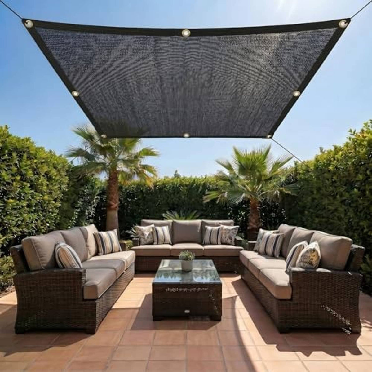 Rectangular black shade cloth canopy with brass grommets, stretched over yard