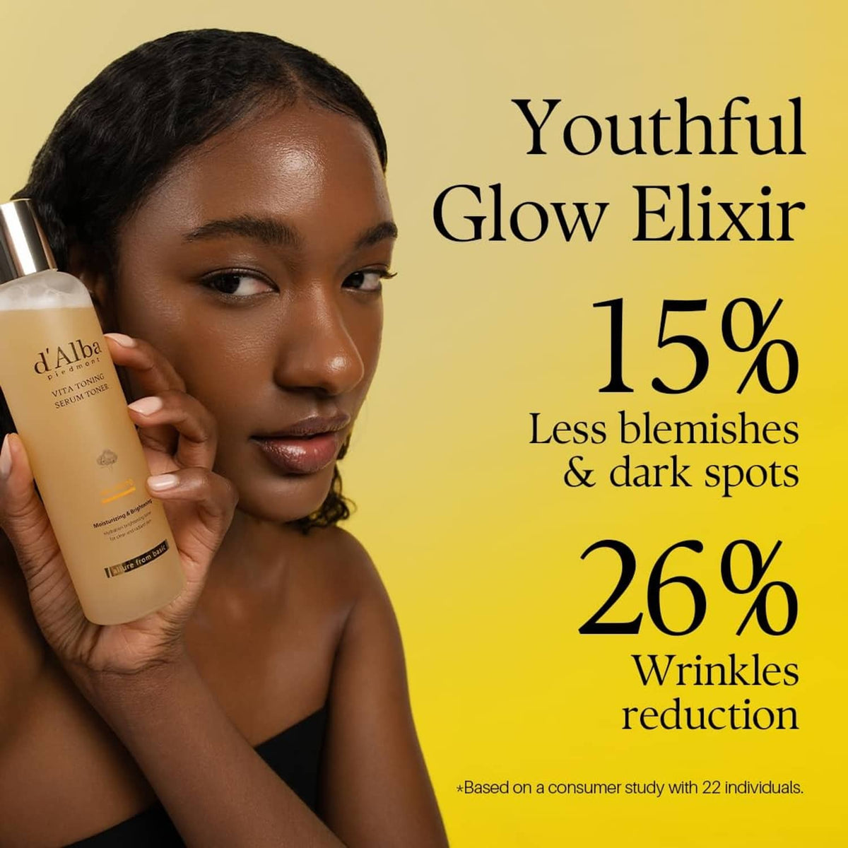 d'Alba Vita Toning serum toner bottle held beside face, yellow liquid and gold cap