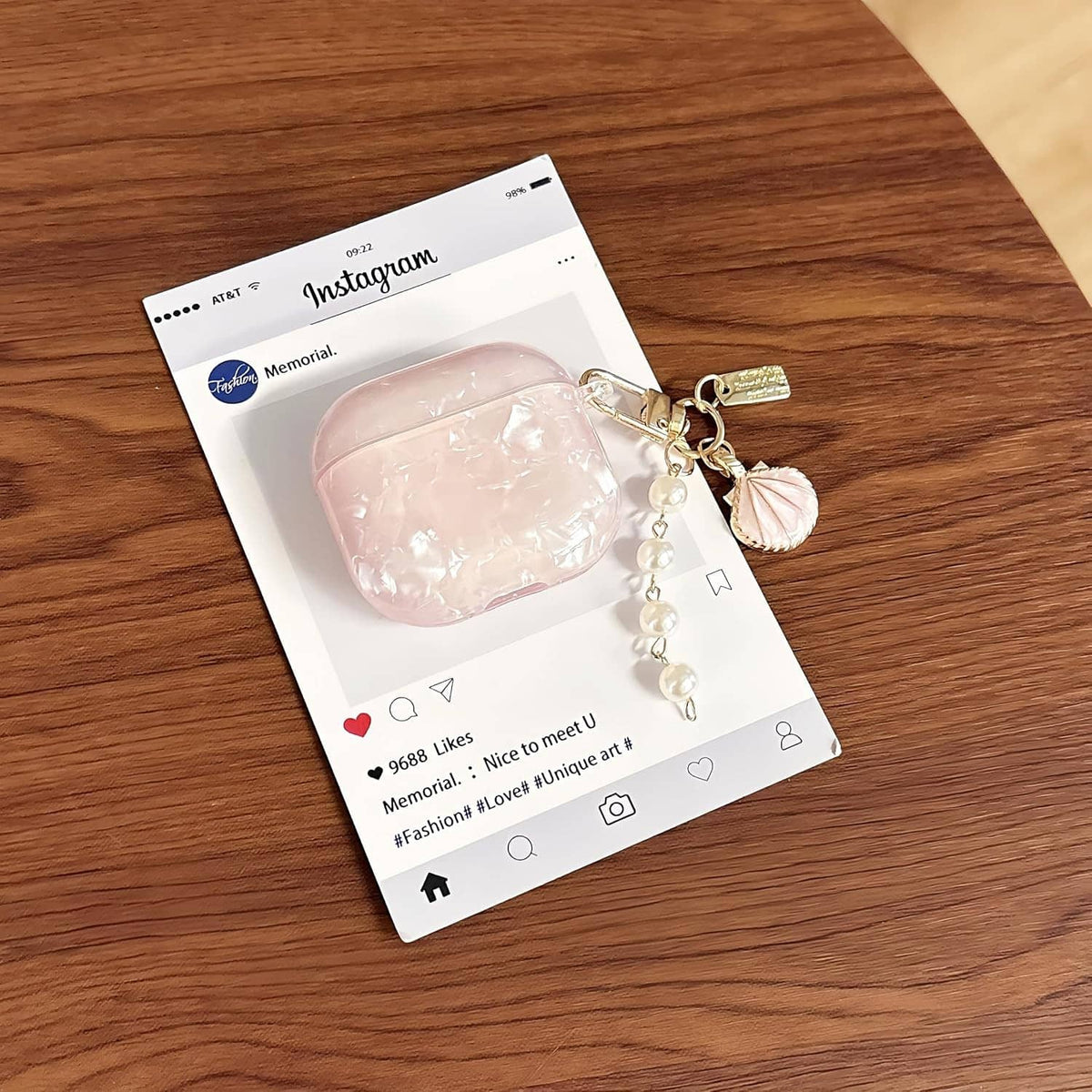 Pink glitter TPU AirPods case with pearl keychain charm, shown on phone packaging