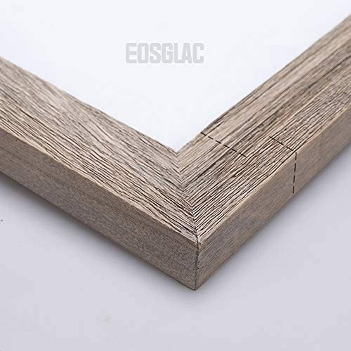 Wooden picture frame corner with distressed gray finish and mitered edge
