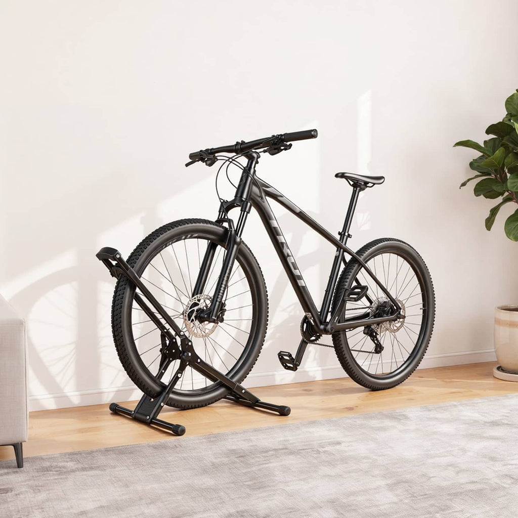 Black freestanding bike storage rack holding a bicycle indoors