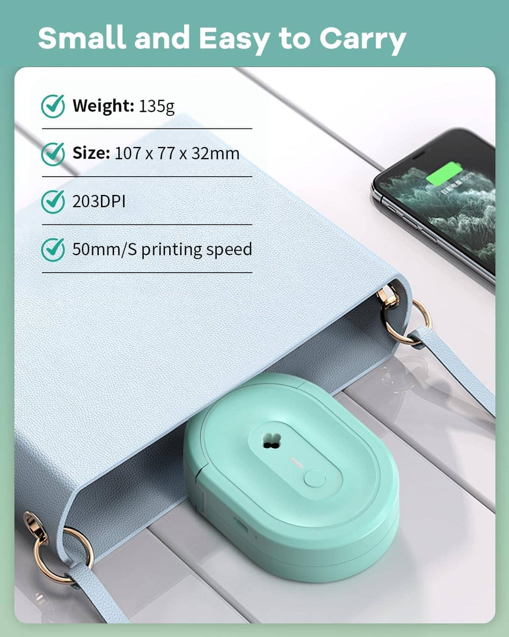 Compact turquoise N12 label maker with keychain strap and USB cable, next to phone