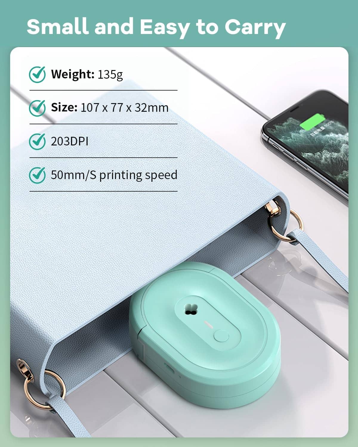Compact turquoise N12 label maker with keychain strap and USB cable, next to phone