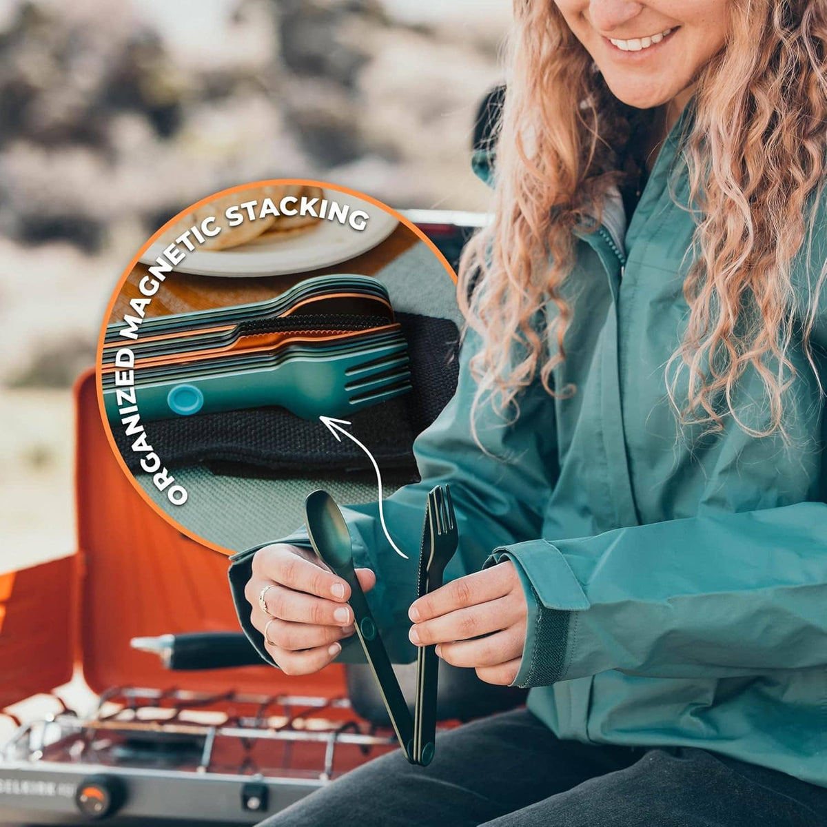 Green Magware magnetic cutlery set in a pouch held by a person: spoon and fork