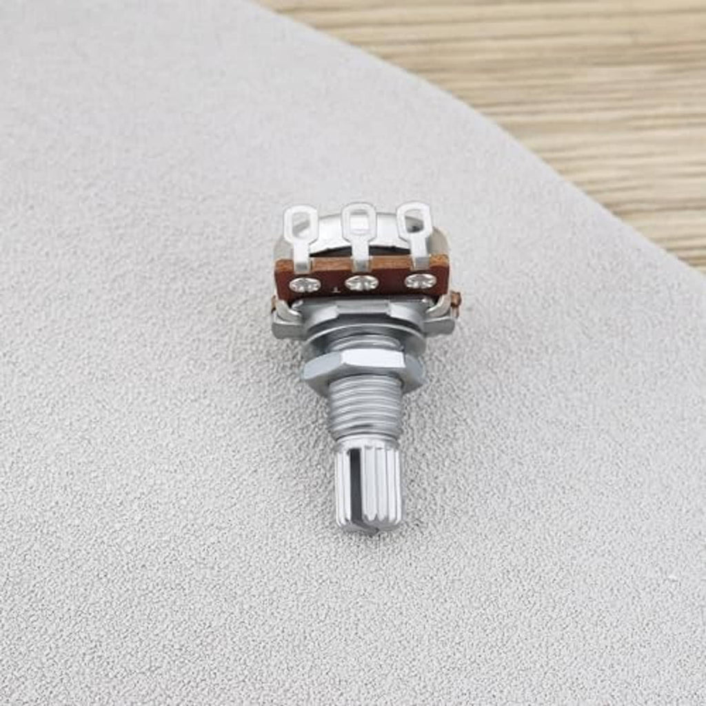 Single linear potentiometer knob on tabletop, with knurled metal top and brown contact board
