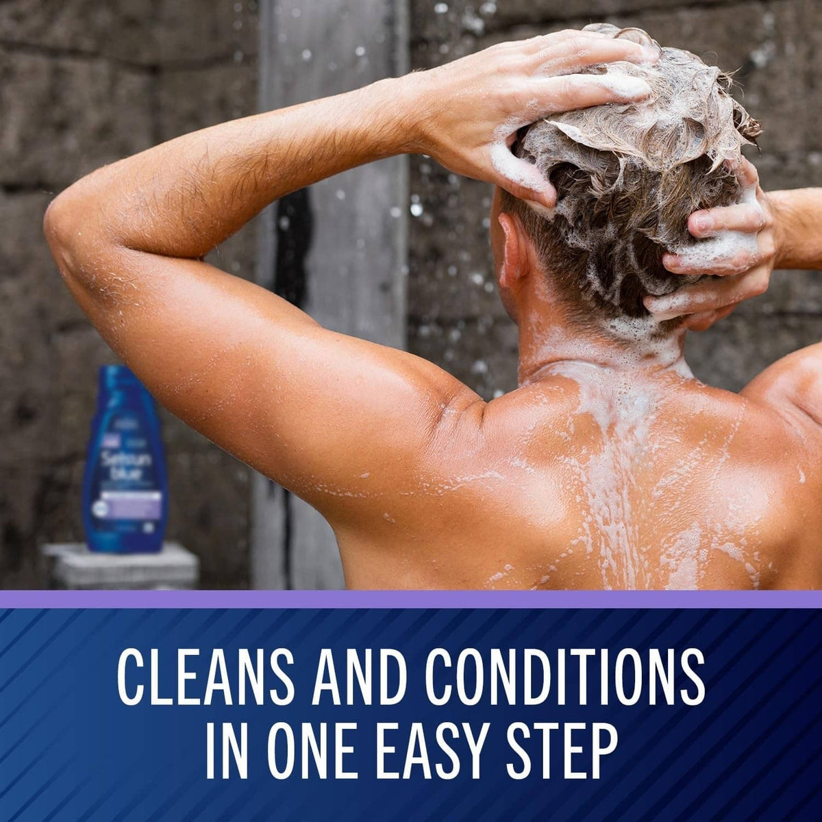 Person lathering hair with white shampoo foam while rinsing in shower