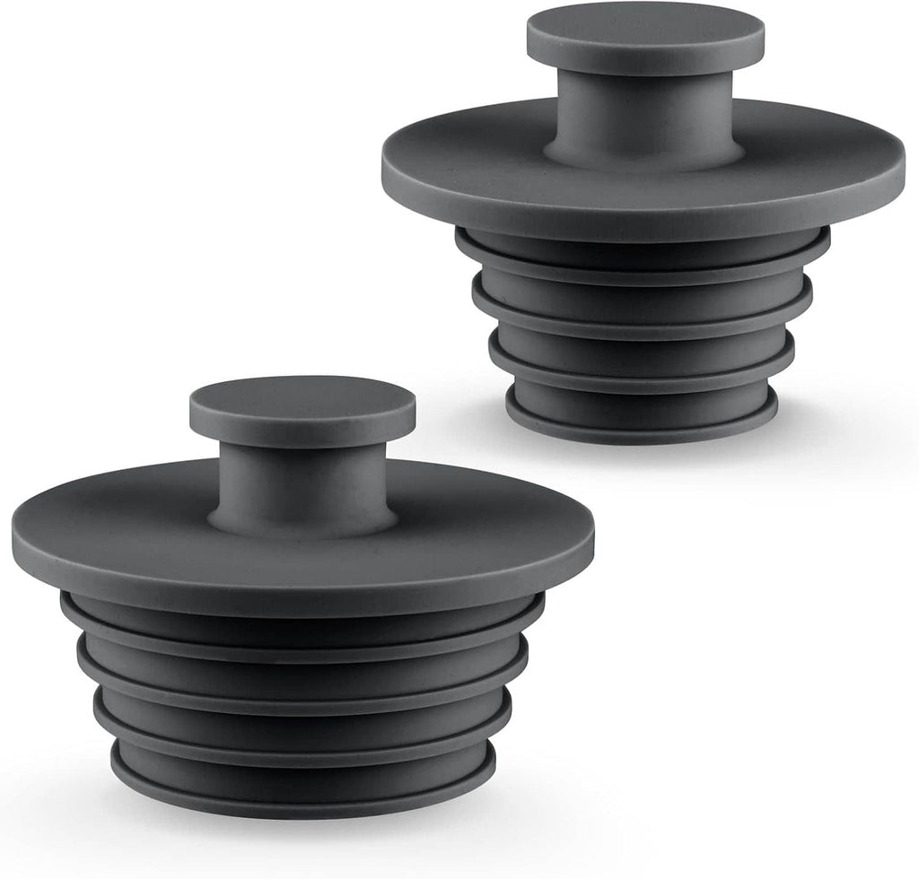 Two dark gray silicone sink/tub drain stoppers with plug tops and ridged stems